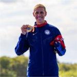 Chris Hammer poses for a photo with his gold medal after winning his Para Triathlon event at the 2024 Paris Paralympic Games.